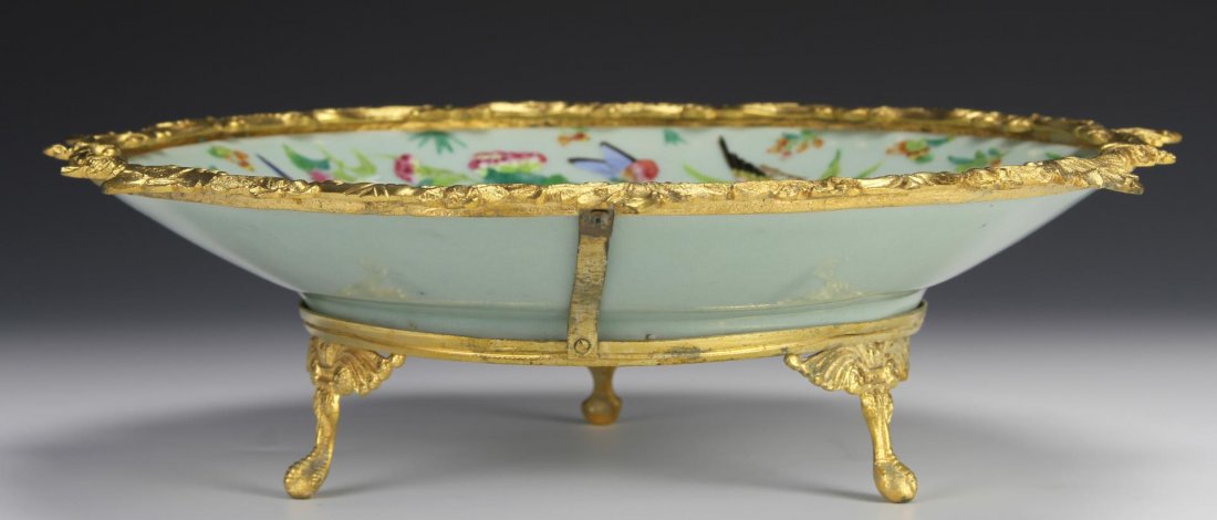 Chinese Famille Rose Plate: China, very fine antique Famille Rose plate decorated with birds, butterflies, and flowers, ormolu mounted. Diameter 11 1/2 in., Height 3 1/4 in.