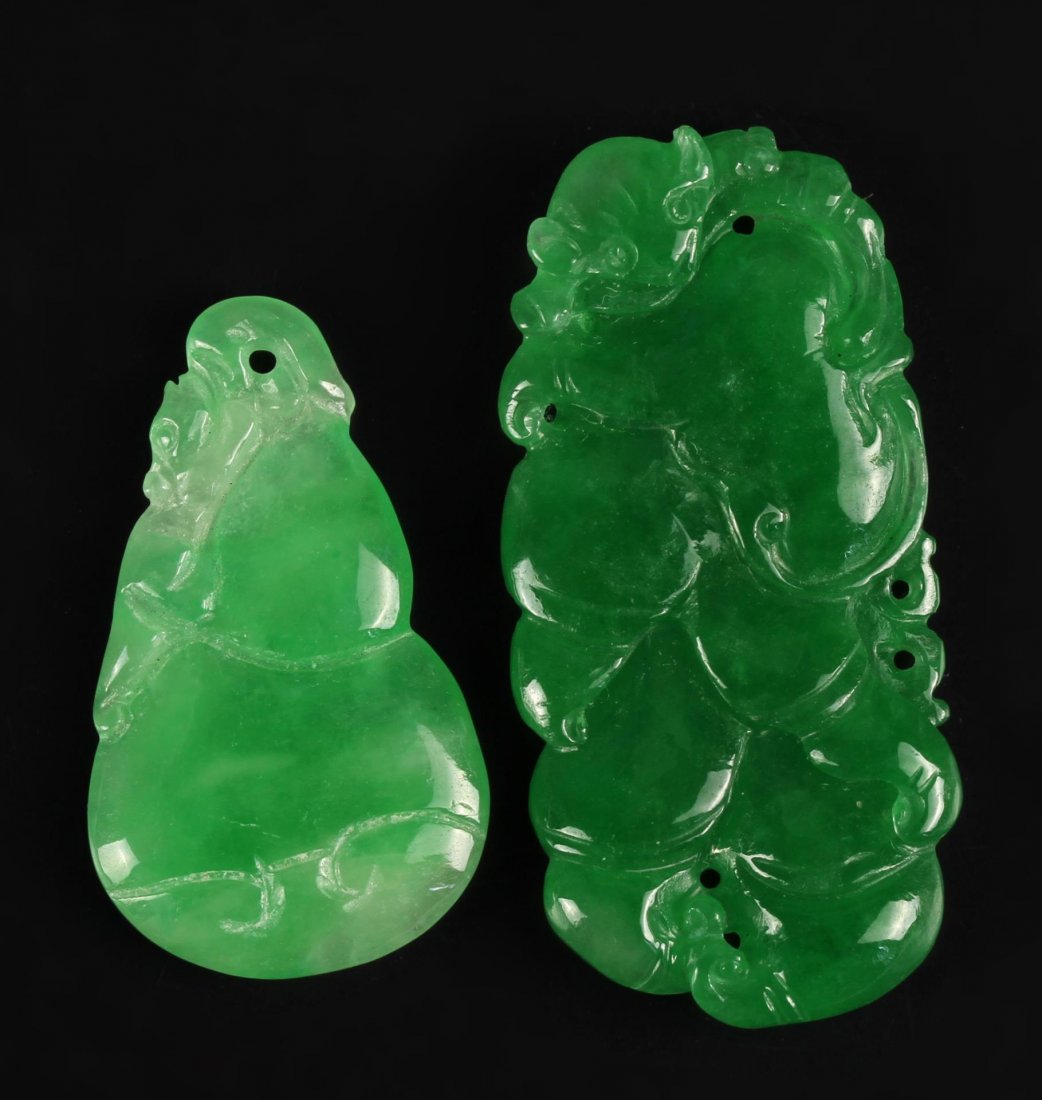 Two Chinese Jadeite Pendants: China, two lovely jadeite pendants, each is pierced with a hole for hanging, and both have animal faces peering out from the carving. Length 1 3/4 in.