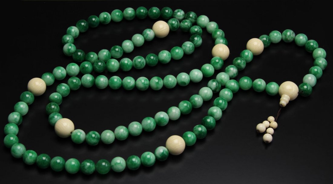 Chinese Jadeite Buddhist Prayer Beads: China, 20th C., jadeite Buddhist prayer beads, spaced with ivory beads. Length 55 in.
