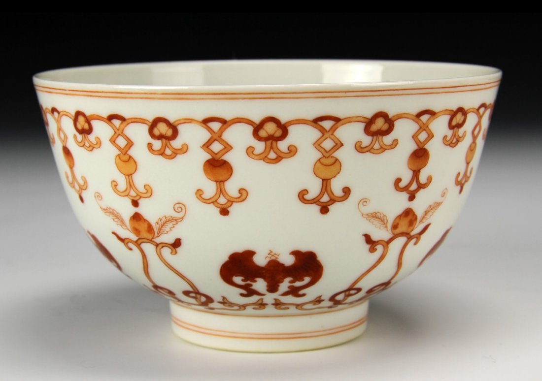 Chinese Red Glazed Bowl: China, red glazed bowl painted with bats, auspicious symbols, and banded decoration, Guangxu mark. Height 2 3/4 in., Diameter 6 7/8 in.