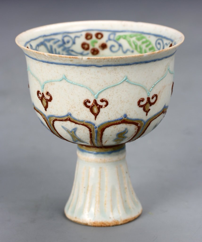 Chinese Wine Cup: China, Yuan Period, grayish white porcelain wine cup with gold, brown, light green and blue decorations on exterior, with some gilt decorations inside the cup, minor chips on rim. Height 3 1/2 in., Di