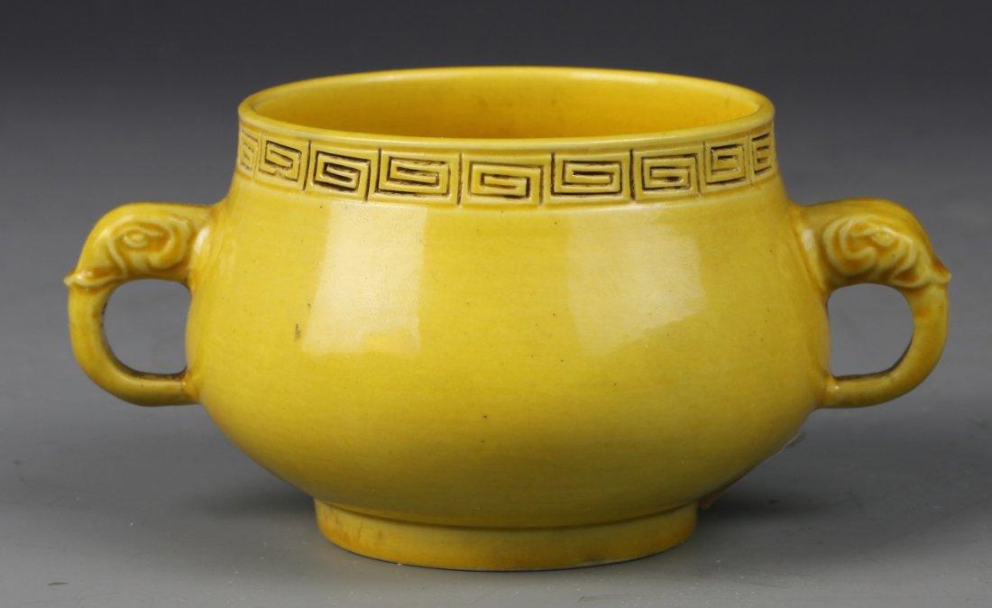 Chinese Yellow Glazed Censer: China, yellow glazed censer, key fret design at rim, footed base, two elephant trunks as ears. Height 4 in., Length 2 in.