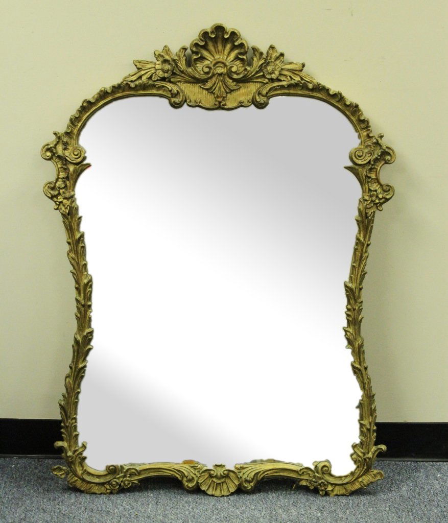 Antique Italian Style Mirror: Italy, antique style mirror, wide bodied with decorative gilt edging in leaves, reeds, flowers and scalloped shells. Provenance: From the estate of Nick Sampson, Uxbridge, MA. Height: 41.5 in., Width: