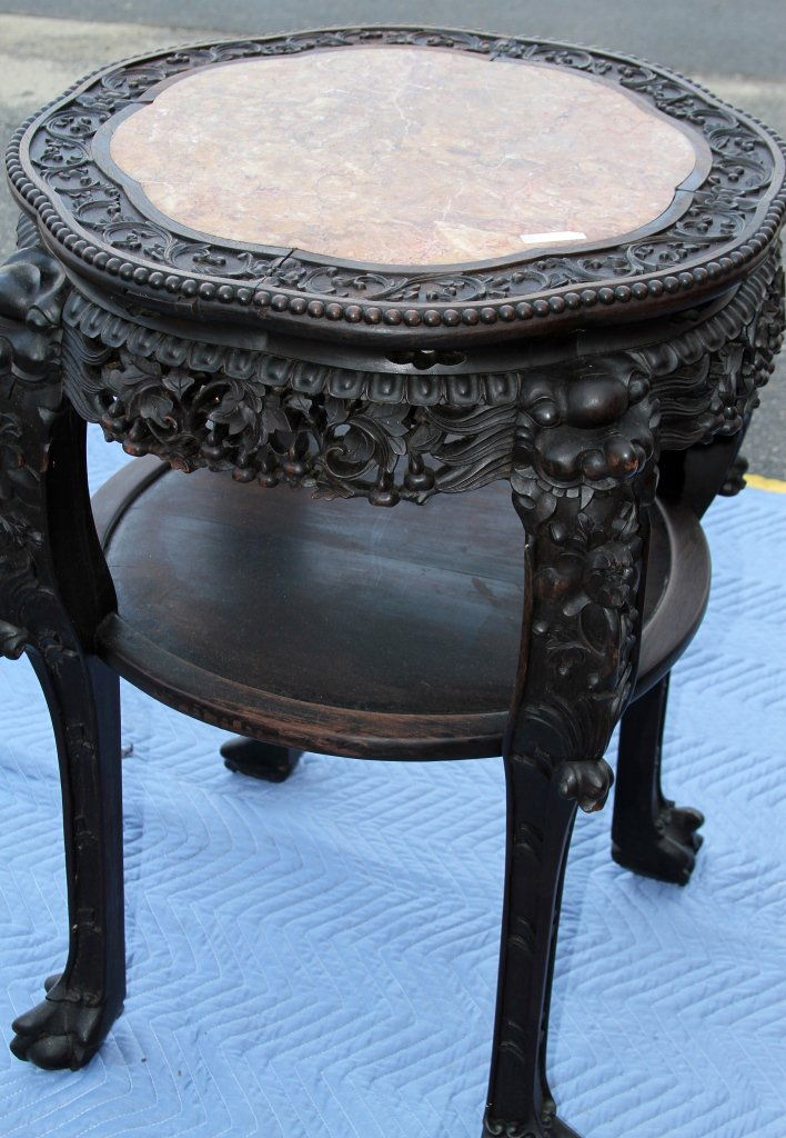 Chinese Marble Topped Hongmu Table: China, marble topped Hongmu wood table, slightly rounded, octagonal shaped surface, carved floral motif along rim, sides and legs, additional flat surface below the tabletop, footed legs. Height 32 in