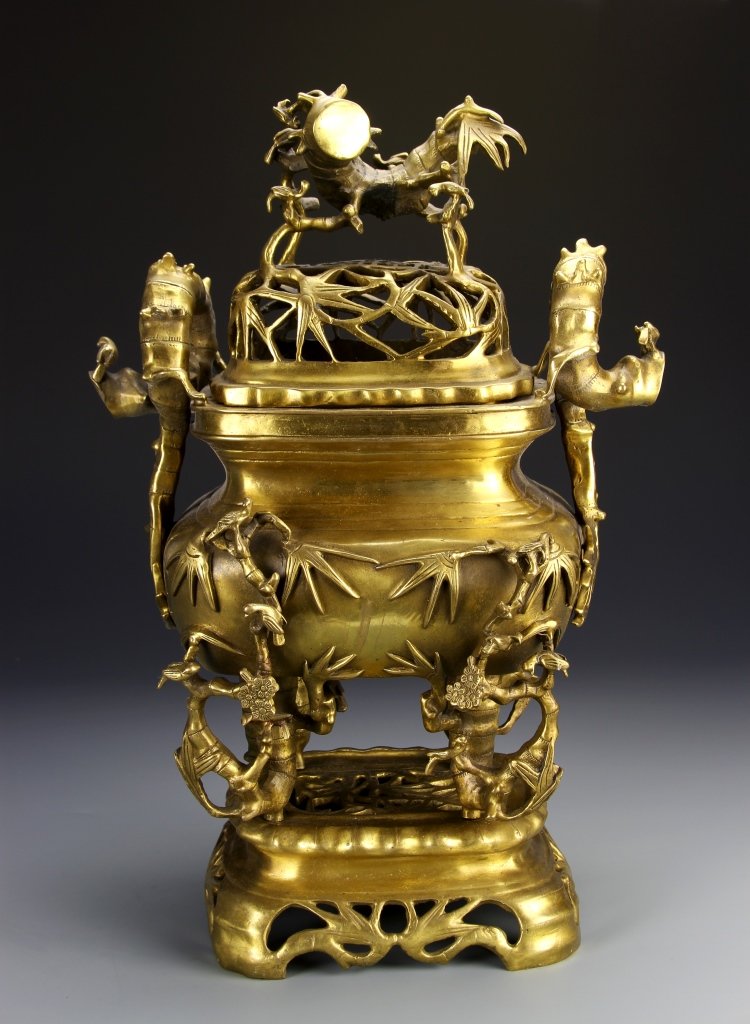 Chinese Brass Incense Burner: China, 19th C., large brass incense burner with stand, decorated with a bamboo tree motif, the finial in foo lion motif. Height 16 in.