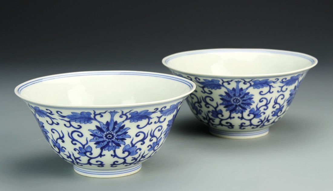 Pair of Chinese Blue and White Bowls: China, 19th C., pair of blue and white bowls, blue double line encircles the exterior and interior rim and base, with floral interlocking design around the sides and Guangxu mark on base. Height 2 3/4