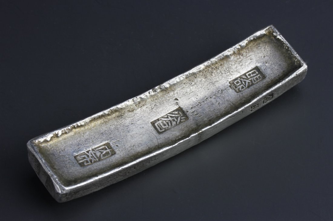 Vietnamese Silver Currency Block: Vietnam, 19th C., silver currency block, with various stamps and inscriptions. Length 4 3/4 in., Width 1 1/4 n., Weight 357 g.