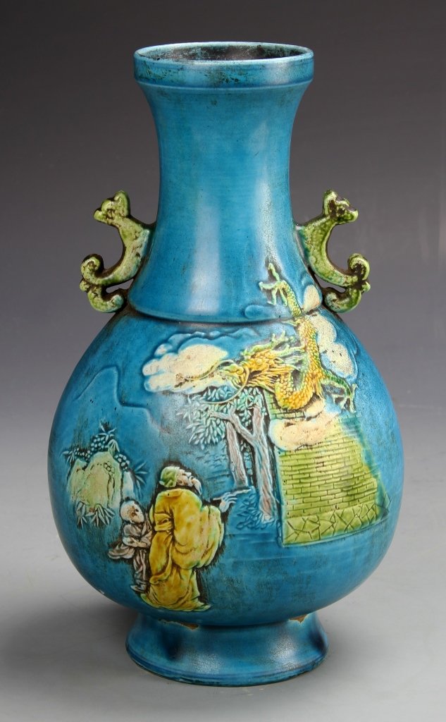 Chinese Turquoise Glazed Vase: China, footed turquoise glazed vase with a long neck flanked by two decorative ears, features painted landscape scene of two characters meeting an auspicious dragon, Yongzheng mark on base. Height: 9.