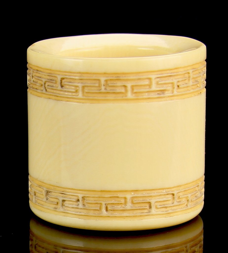 Chinese Carved Ivory Ring: China, 19th C., carved ivory ring with auspicious symbols in relief. Length 1 1/8 in., Width 1 1/8 in.
