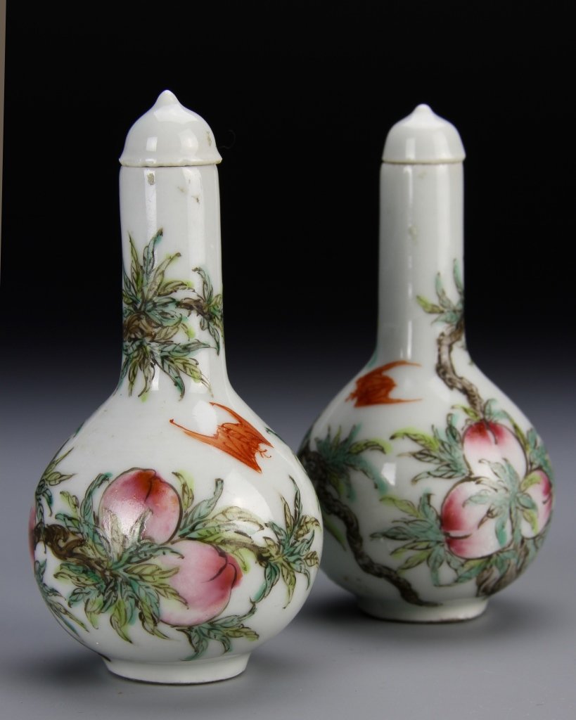 Pair of Famille Rose Vase: China, 19th C., a pair of Famille Rose vases, with fitted dome shape lids, decorated with red bats flying around ripe peach trees. Height: 3 1/4 in.
