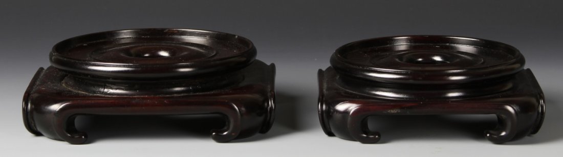 Chinese Carved Stands: China, 20th C., set of two stands, one larger than the other, mimicking same rounded edge style. Width 5 1/2 in., Height 1 3/4 in.