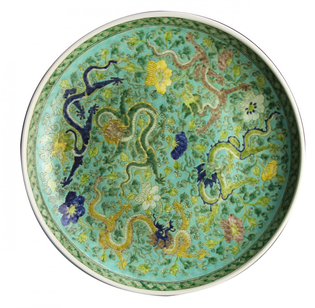 Chinese Famille Rose Plate: China, Famille Rose plate, densely decorated throughout with vibrant colored five-clawed dragons and scrolling, interlocking lotus flowers, with Kangxi mark on the base within a double blue circle. Di