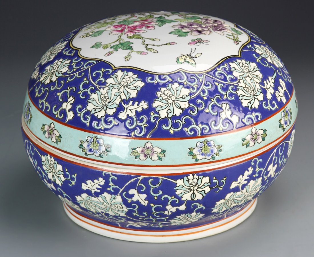 Chinese Famille Rose Round Box: China, Famille Rose round box with cover, ovoid shape, painted throughout in rich blues, central medallion of flowers and insects with floral motifs and borders, red signature seal on flat base. Diame
