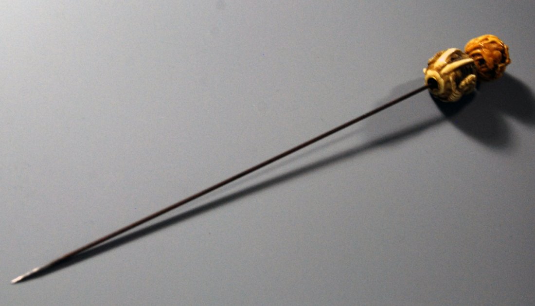 Japanese Metal and Ivory Hair Pin: Japan, metal hair pin with two intricately carved ivory balls on the end in orange and cream colors. Length 8 1/2 in.