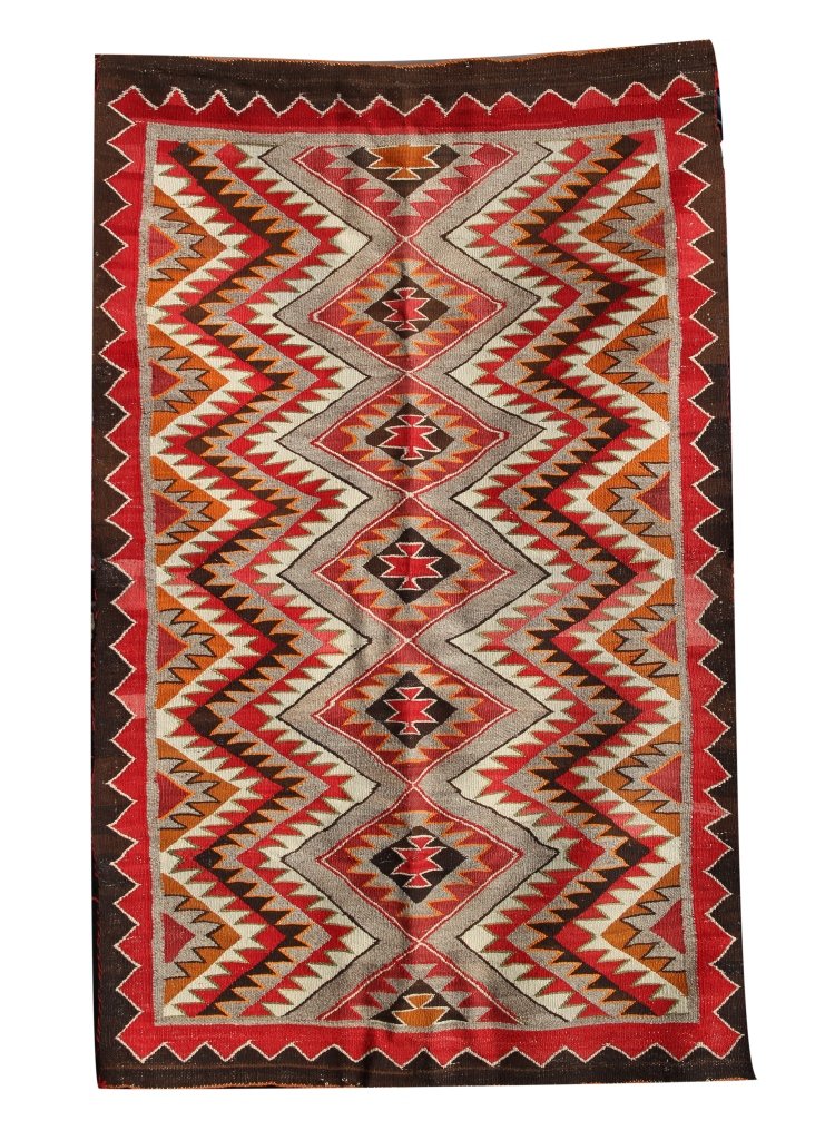 Navajo Eye Dazzler Rug: Navajo, eye dazzler rug, unusual color combination, brown, black, red, orange, green, rust. Length 69 in., Width 44 in. Provenance: From the estate of Dr. Robert Goodwin.