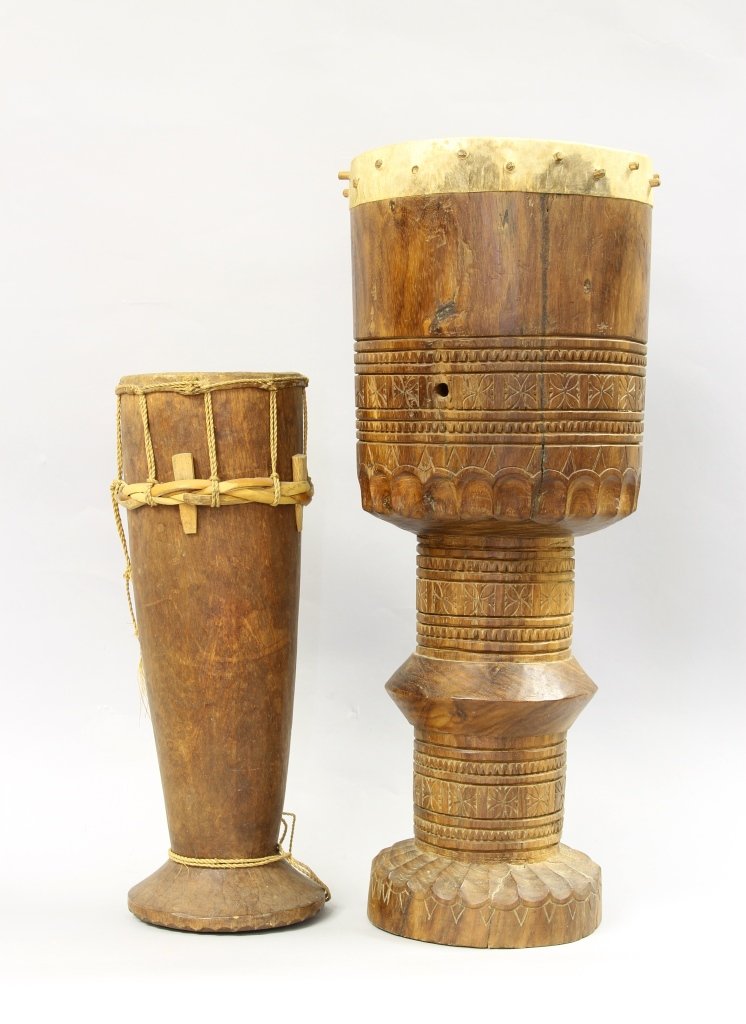 Two Timorese Ceremonial Drums: Timor, two ceremonial drums; one carved rosewood male ceremonial drum. Height 18 in; one wood shoulder drum with a goat hide cover, Height 13 in. Provenance: From the Dr. Robert Goodwin Collection, co