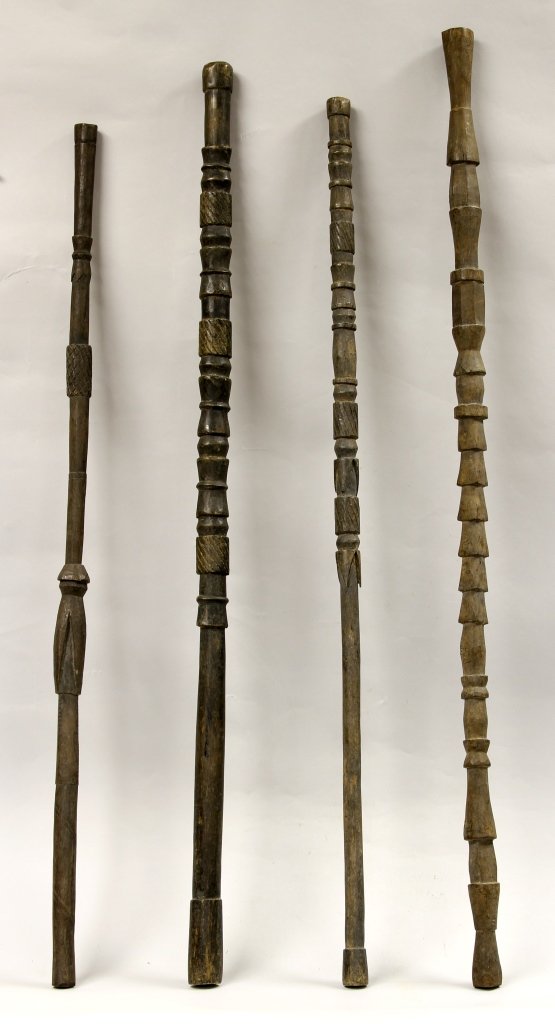 Four Kiwai Island Walking Sticks: Kiwai Island (Papua New Guinea) West District, four carved wood walking sticks, purportedly a museum de-accession, all c. 1920-1940. Lengths ranging between 37 and 40 in. Provenance: From the Robert G