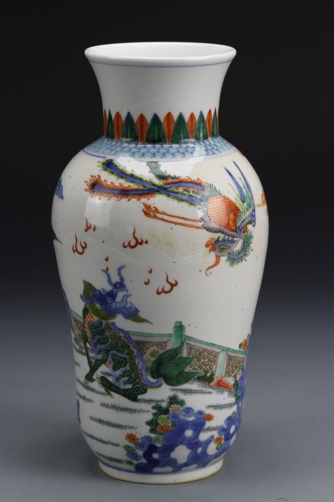 Chinese Wucai Vase: China, Wucai vase painted in bright colors with a scene of a dragon and a mythical bird, engaged in fighting, Kangxi mark, double ring. Height 10 in., Width 5 in.