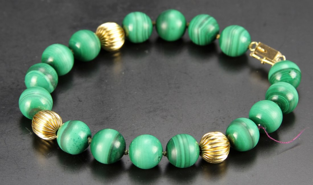 Chinese Agate Necklace: China, agate necklace, consisting of sixteen green beads, divided by three gold beads, with a gold clasp. Length 15 in.