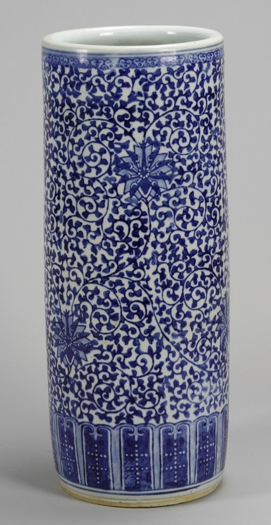 Chinese Blue and White Umbrella Stand: China, 19th C., blue and white umbrella stand, elaborately decorated in a beautiful scrolling lotus pattern, designed with a thicker band on the bottom. Height 24 in., Width 9 1/4 in.