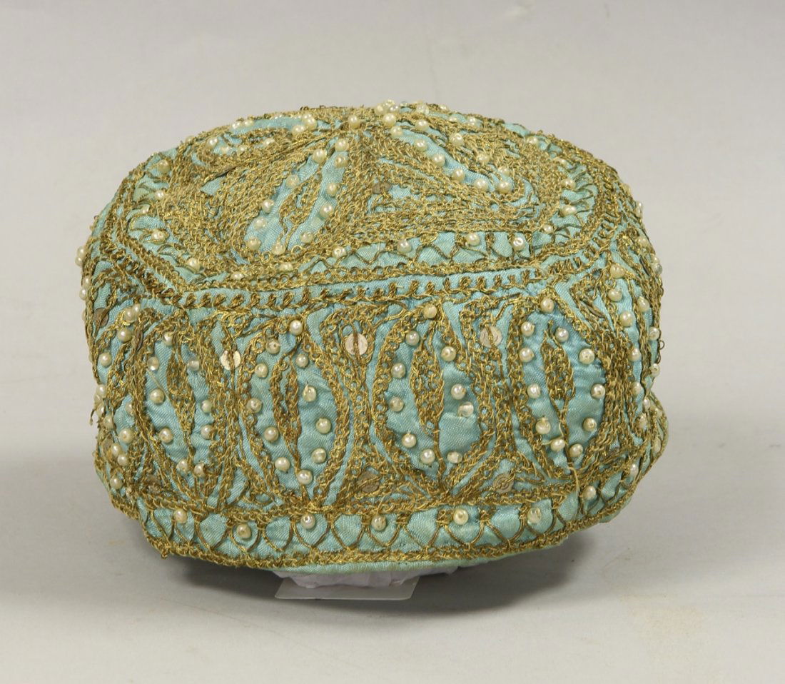 Ottoman Female Prayer Cap: Turkey, Ottoman, female prayer cap, in a pale green fabric, elaborately decorated with gold embroidery, seed pearls, glass. Height 3 1/4 in., Diameter 7 1/4 in. Provenance: From a Private Seattle Esta
