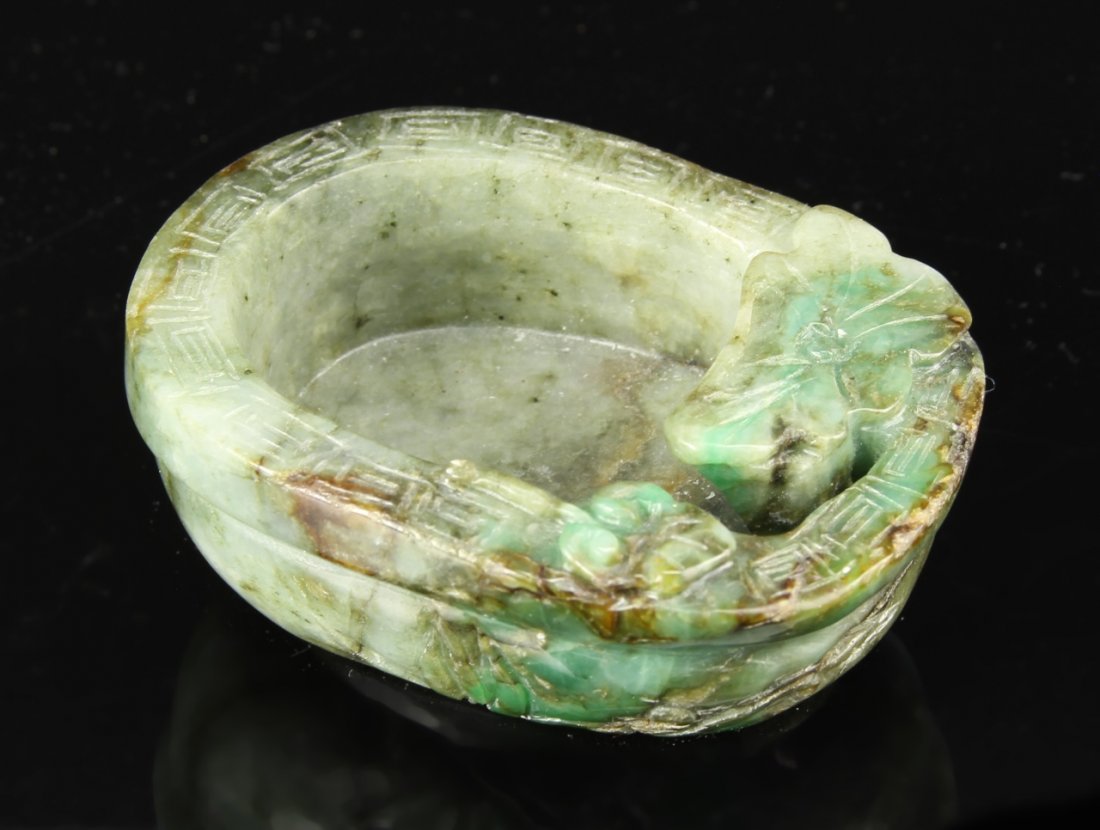 Chinese Jadeite Brush Washer: China, carved jadeite brush washer, decorated with natural motifs in relief and a carved band of key fret patterning. Diameter 3 in., Height 1 1/4 in.