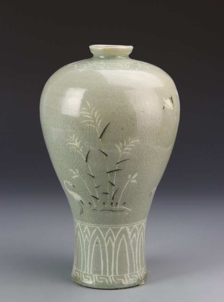 Korean Celadon Glazed Meiping Vase: Korea, Celadon glazed vase, in Meiping form, decorated with a white and brown slip of petal lappets at the base and cranes and flowers around the waist, minor repair on rim. Height 12 in.