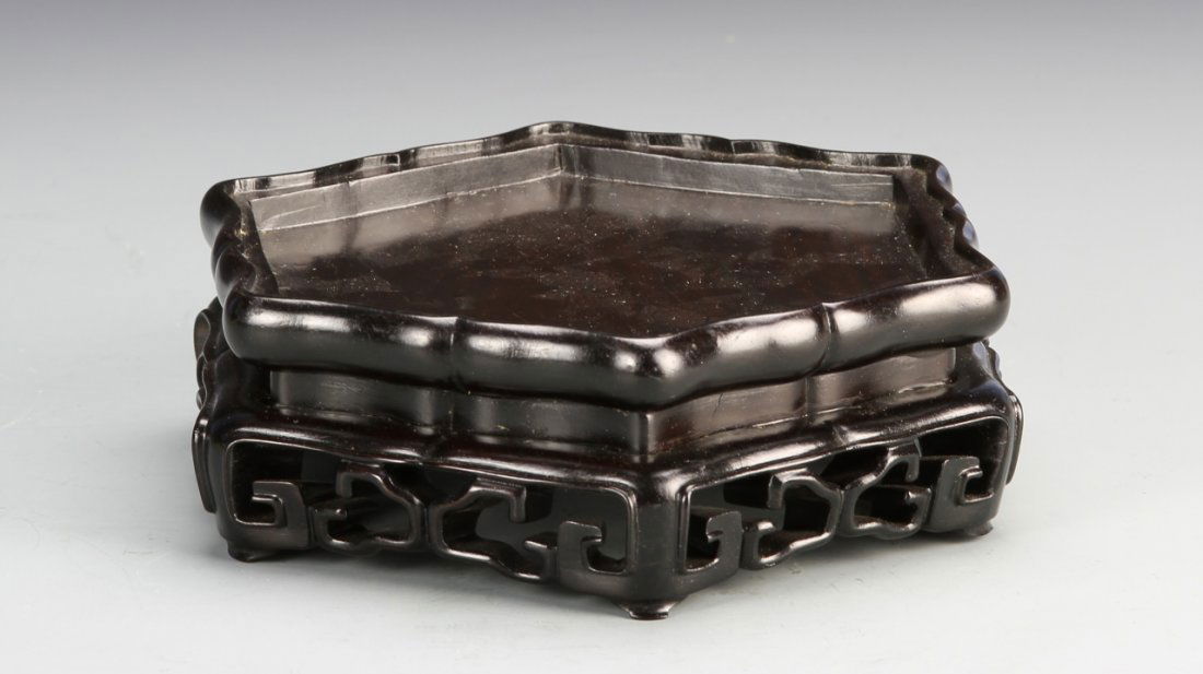 Chinese Carved Wood Stand: China, carved wood six-sided stand, with an openwork design of traditional motifs. Width 6 3/4 in., Length 5 3/4 in., Height 2 1/8 in.