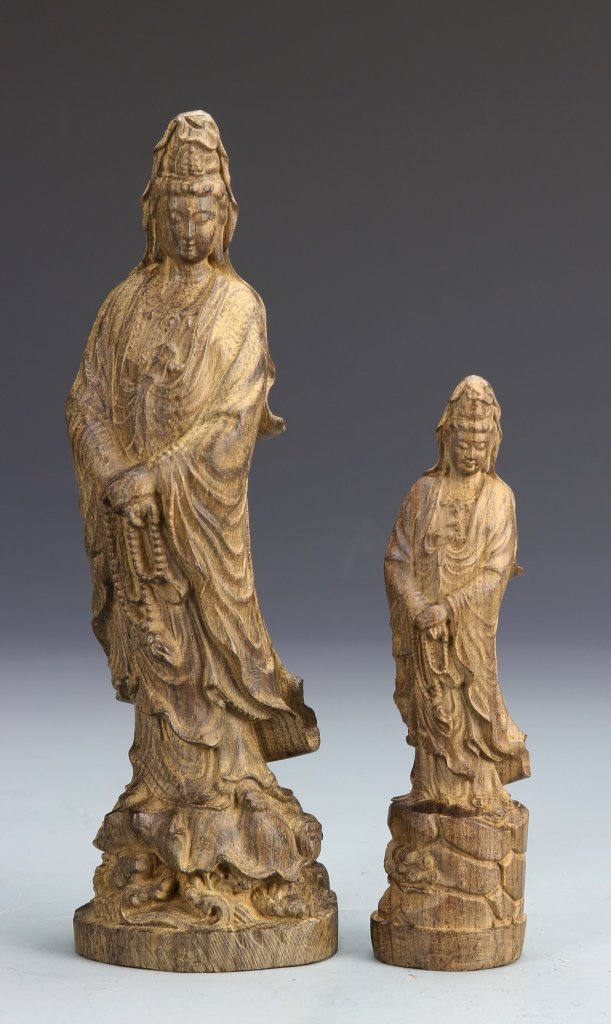 Two Chinese Chenxiang Wood Buddhist Figures: China, two carved Chenxiang wood Buddhist figures, of Guanyin, in flowing robes, on sculptural bases. Height 8 3/4 in.