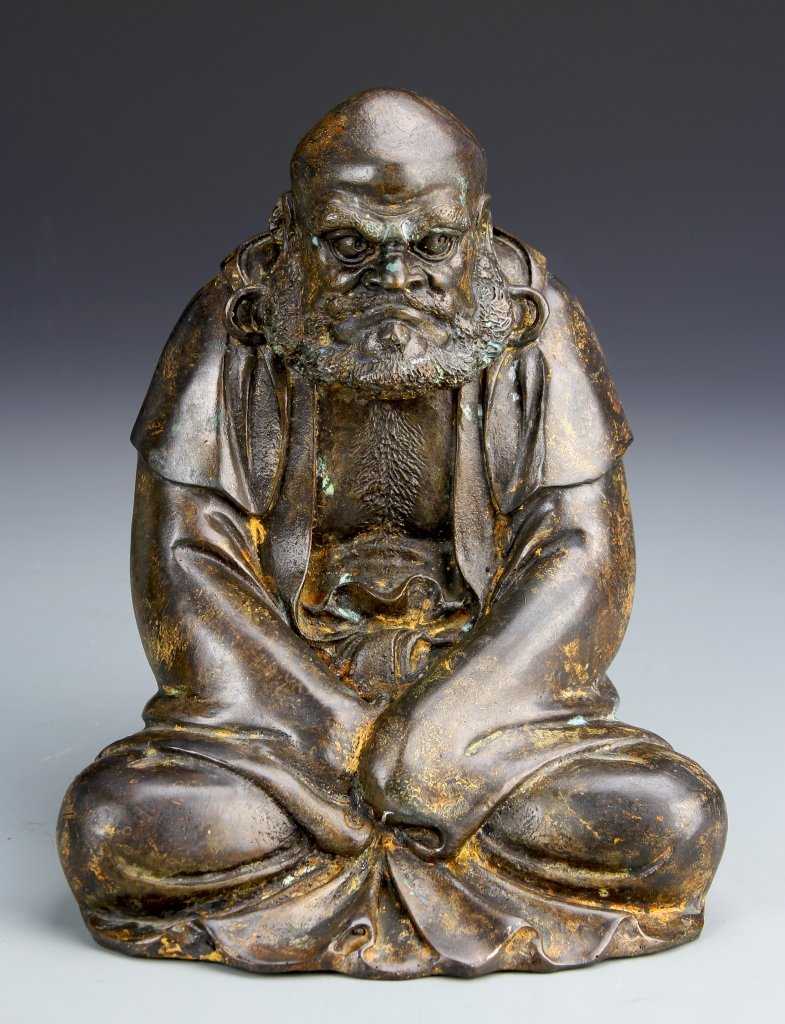 Chinese Antique Bronze Daimara Buddha Statue: China, antique bronze Daimara Buddha statue, seated, robed figure, with bald head and curly, long beard, patina throughout. Height 8 1/4 in.