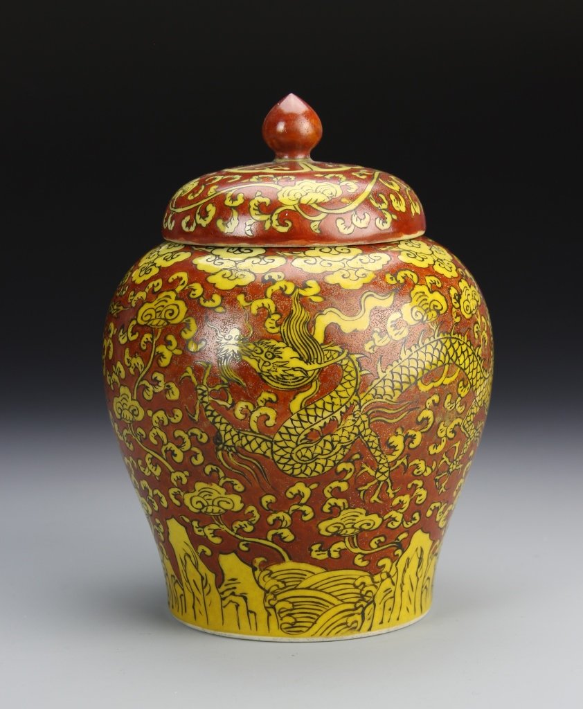 Chinese Yellow and Red Glazed Jar: China, Ming Period, red glazed jar , with bulbous body and tapered base, with lid, with yellow five clawed serpentine dragon, densely decorated throughout with auspicious symbols and floral motifs, wi