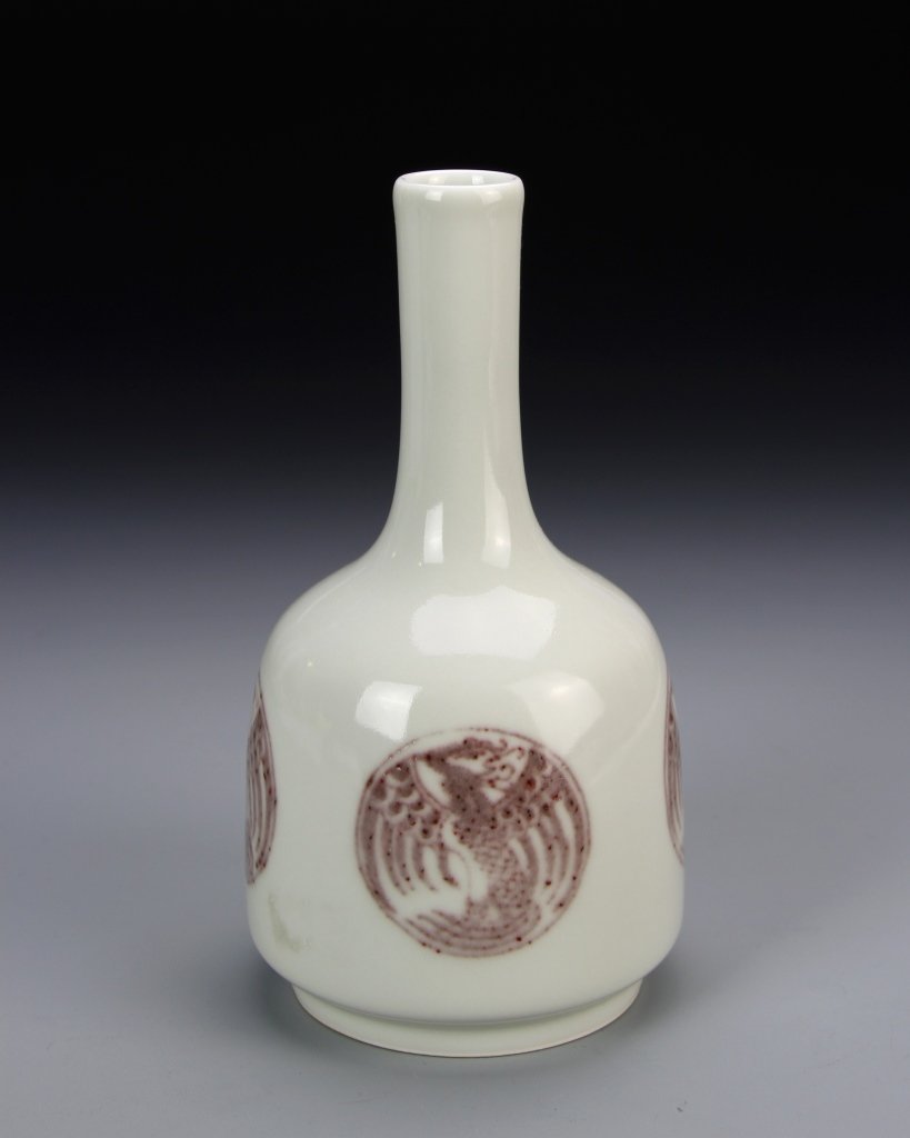 Chinese Copper Red Vase: China, copper red vase, elongated neck with squashed cylindrical body and footed base, with white ground color, copper red circles depicting mythical creatures, with Kangxi mark. Height 6 1/4 in., Wid