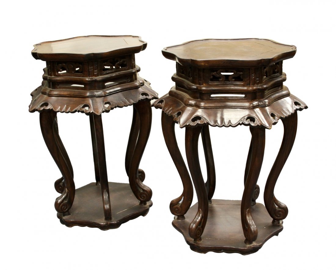 Pair of Chinese Wooden Stools: China, pair of huanghuali wooden stools, expertly carved in a hexagon form with scalloped edges, flared detailing around seat. Height 27 1/2 in.