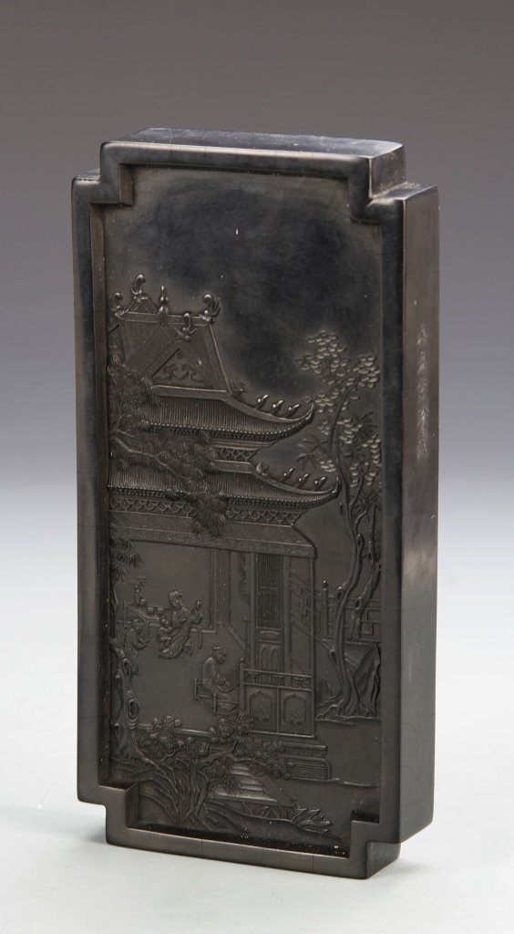 Chinese Ink Block: China, ink block with box, expertly carved, with three figures working in building set in a natural landscape, reverse side has calligraphy in gilt. Length 7 1/2 in., Width 3 3/4 in.