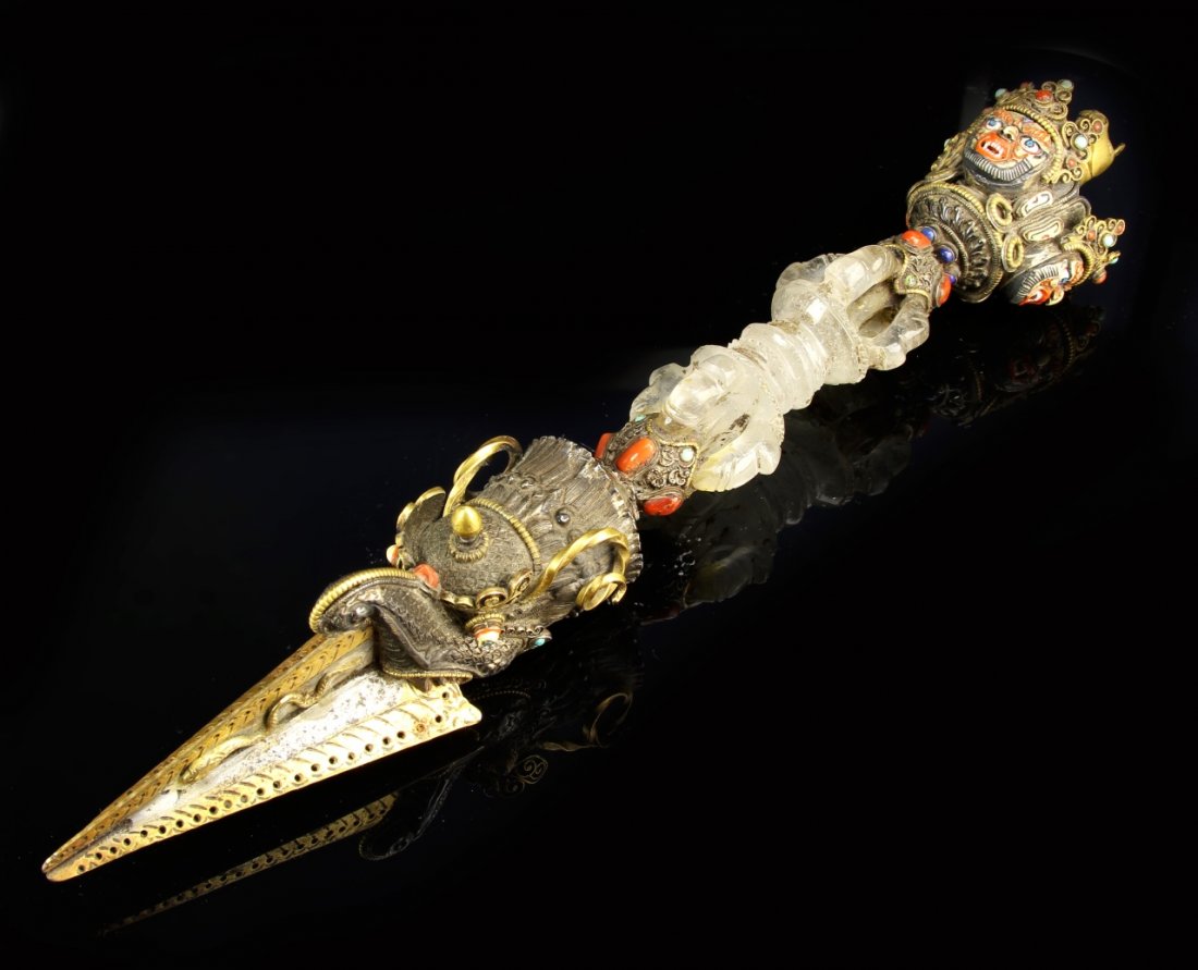 Tibetan Gilt Crystal Buddhist Instrument: China, 18th-19th C., gilt and crystal Buddhist instrument, featuring various carved crystal elements and metal work, with inlaid stones depicting faces, and a horse's head at the top. Length 12 3/4 in