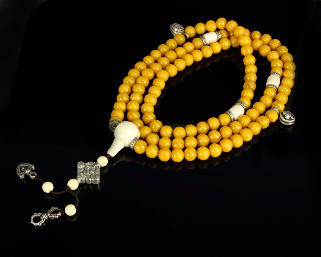 Tibetan Mi-La Buddhist Prayer Beads: Tibet, Mi-La prayer beads composed of 108 round amber (mi-la) beads each 1.1 cm diameter, spaced Overall Length 101 cm.