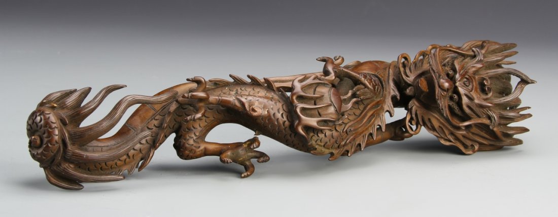 Chinese Boxwood Ruyi Scepter: China, well-carved boxwood Ruyi scepter, in the form of a ferocious serpentine dragon, with crack on back. Length 13 in.