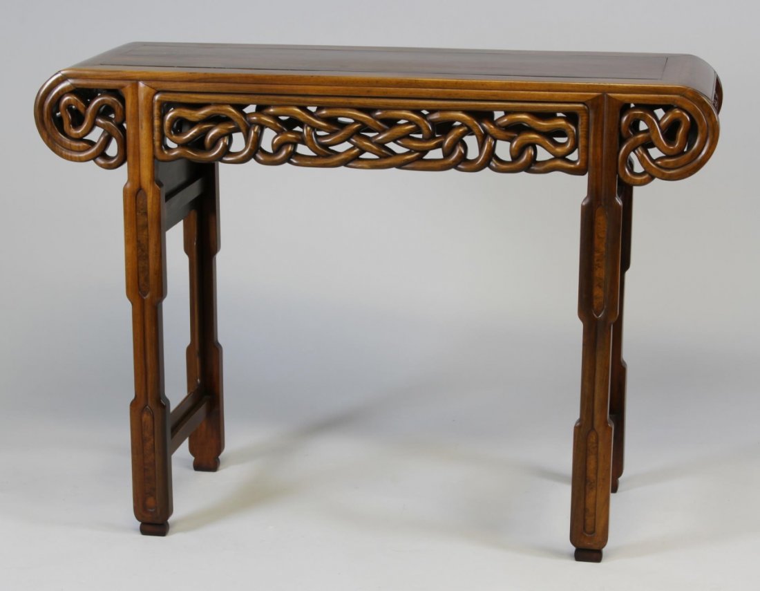 Chinese Huanghuali Altar Table: China, 19th C., very fine and rare Huanghuali altar table with elaborate carvings, the sides are rendered in a repetitive and overlapping vine motif, each end finishes in a scroll form. Height 33 in.,