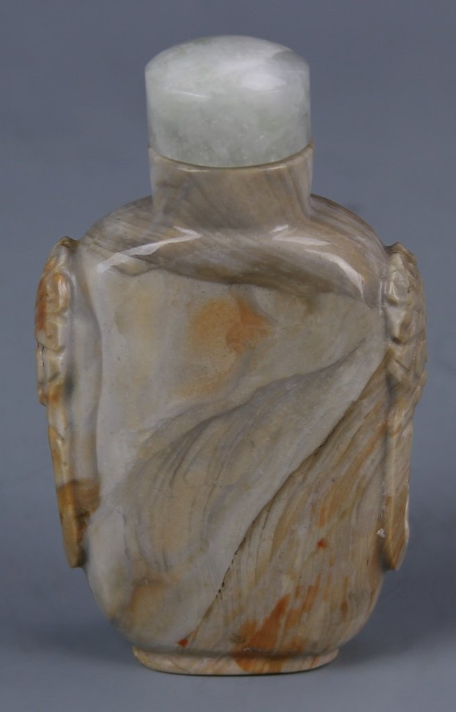 Chinese Carved Shoushan Stone Snuff Bottle: China, carved Shoushan stone snuff bottle, in a rectangular form, with rounded corners and natural curved striations of rich browns and white. Height 2 3/4 in.