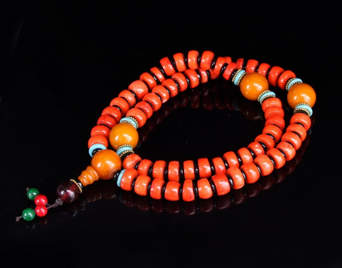 Chinese Tibetan Coral and Wax Bead Necklace: China, Tibetan coral and wax bead necklace, consisting of flat beads strung in four sections divided by larger beads and finished with a beaded tassel. Length 26 in.Federal restrictions prohibit the s