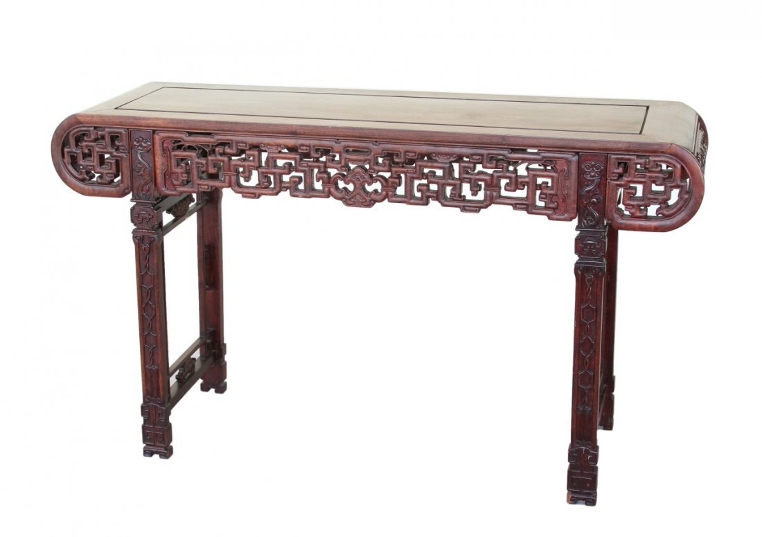 Chinese Huanghuali Altar Table: China, Huanghuali altar table, with carved legs and bracketed underside, and geometric pattern with cut outs. Width 34 1/2 in., Length 60 in., Height 17 1/2 in.