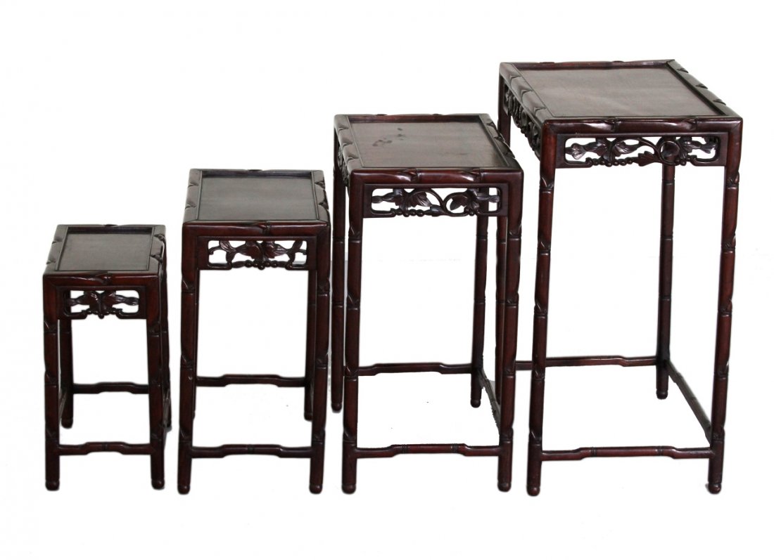 Four Chinese Hardwood Nesting Tables: China, 19th C., a set of four hardwood nesting tables, all with carved legs and stretchers at the base, and carved leaf motifs. Height 28 in., Width 20 in., Length 14 in.