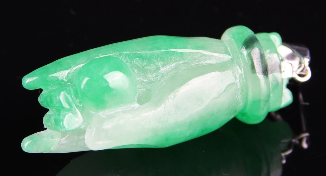 Chinese Jadeite Buddha Hand Pendant: China, jadeite Buddha hand pendant, holding a ball with two of the fingers, in a mottled bright green and white hue, with platinum pin, contains some minor damage. Height 1 3/4 in.