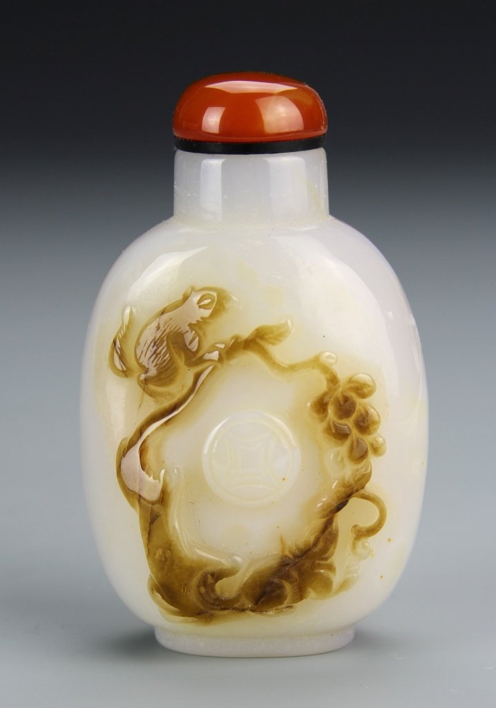Chinese Agate Snuff Bottle: China, 19th C., agate snuff bottle, flattened ovoid form, decorated with squirrel and grapevine scene, with stopper. Height 3 in.