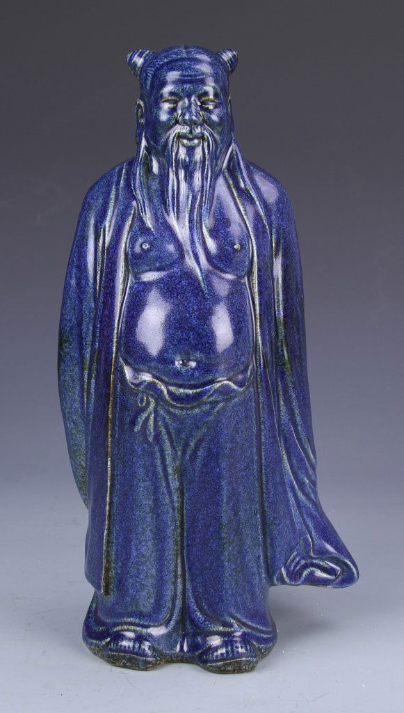 Chinese Blue Glazed Man: China, 19th C., blue glazed man, covered all over in a bright blue glaze, with open flowing robe and protruding belly, with highly detailed beard, with Xuande mark at back. Height 14 1/2 in.