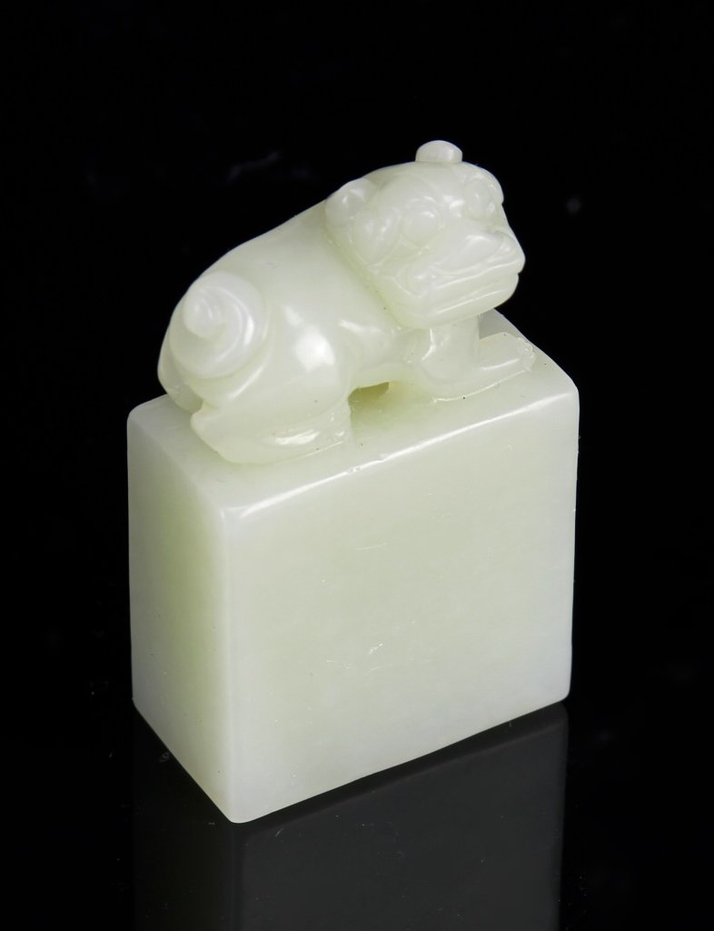 Chinese Jade Seal Chop: China, Jade seal chop, rectangular in form, with strong edges, white in color, high shine polish, smooth surface, dog figure resting on top. Height 2 1/8 in.Provenance: From private jade collections f
