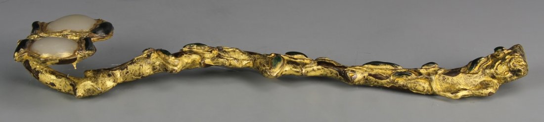 Chinese Gilt Bronze Ruyi Scepter: China, 19th C., gilt bronze ruyi scepter, ornamented into a natural tree branch form brightly gilded, the head of the scepter with two large stones in a white hue. Height 11 in.