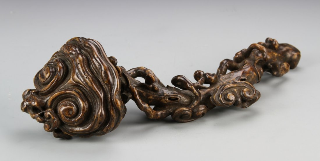 Chinese Bamboo Ruyi Scepter: China, 19th C., intricately carved bamboo ruyi scepter, with swirling natural motifs at the sides, textured surface, and natural wood grain. Length 13 3/4 in.
