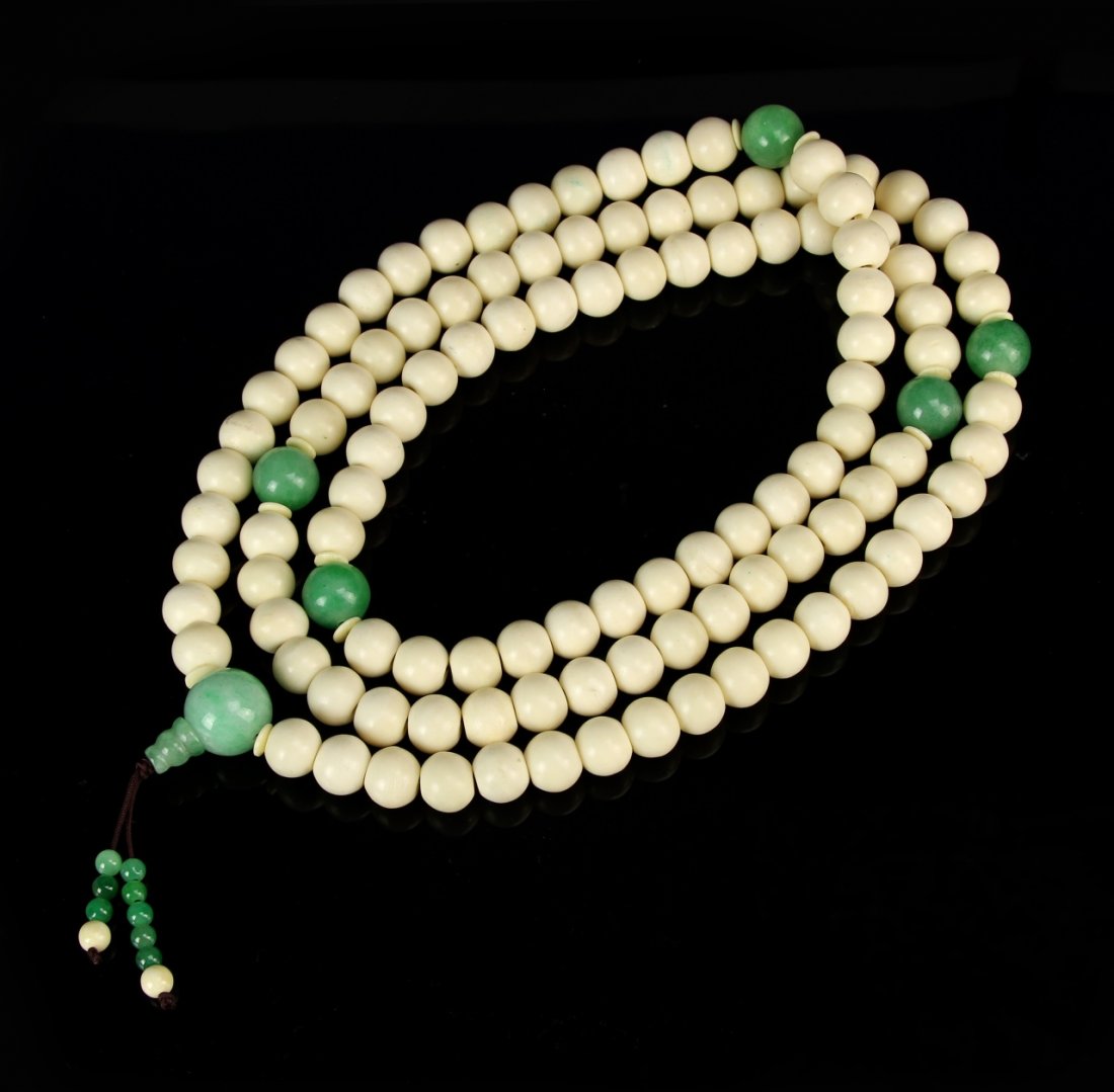 Chinese Ivory-Jadeite Buddhist Prayer Beads: China, ivory and jadeite Buddhist prayer beads, consists of 108 round beads each 1.5 cm diameter, spaced with larger jadeite beads. Length 46 in.