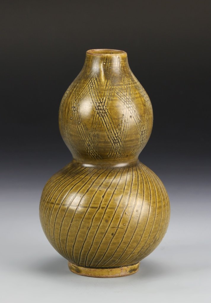 Chinese Antique Yao Zhou Ware Gourd Vase: China, antique Yao Zhou ware gourd vase, with incised linear designs across the body, in a dark green color. Height 6 3/4 in.